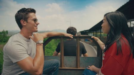 Antoni Porowski and Awkwafina ride the tractor at Cheongdom Farm.  (National Geographic)