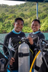 Renowned photographer and local dive guide, Benhur Sarinda, preparing for a dive on the Lembeh Strait with fellow dive guide, Rei Kanaling.  (National Geographic for Disney/Annabel Robinson)