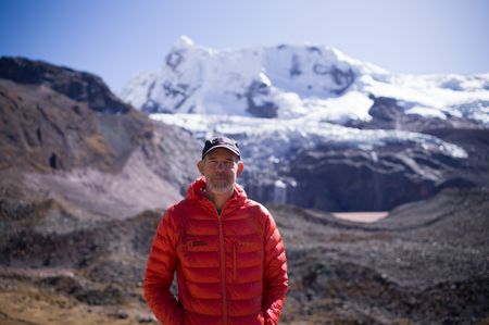 Portrait of National Geographic Explorer Baker Perry beneath Nevado Ausangate in the Peruvian Andes. (credit: National Geographic/Justen Bruns)