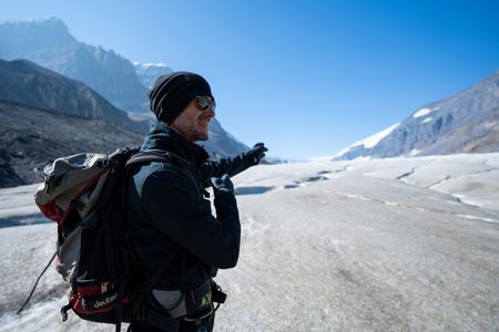 Joseph Fiennes stands on the Athabasca Glacier.  Sir Ranulph Fiennes, "the greatest living explorer," and his cousin, actor Joseph Fiennes, revisit Ran’s 1971 expedition of Canada’s British Columbia.