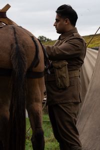 Corporal Chaudry Wali (played by Ali Afzal) stands near a mule in a WW2 historic reenactment scene for "Erased: WW2's Heroes of Color." Corporal Chaudry Wali Mohammed was a member of Force K6, an Indian Regiment of mule handlers in WW2. Amidst the chaos of Dunkirk and the advancing German Army, one little-known Indian Regiment fights for victory and independence. (National Geographic/Harriet Laws Herd)