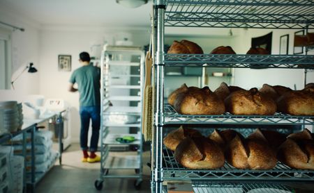 Justin Gomez's loaves cool on bake day in his basement bakery in Martinez, Calif. A cottage baker, Justin produces naturally leavened breads through his home business bakery, Humble Bakehouse. (National Geographic/Ryan Rothmaier)