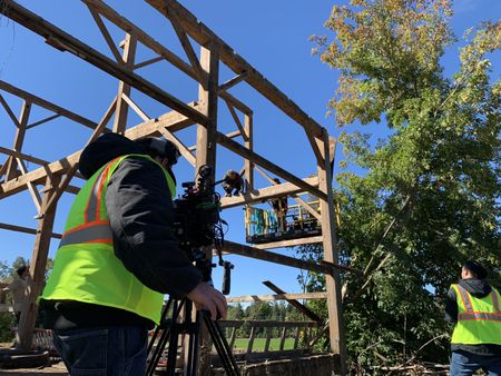 Ben Reinhold and Charles Pol continue to take down an old barn in Lake, MI, while being filmed by crew members. (National Geographic)