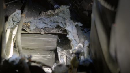 Multiple packages of suspected narcotics are hidden inside the center console of a suspect's vehicle in Brownsville, Texas. (National Geographic)