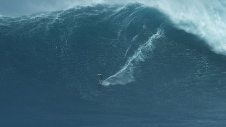 Justine Dupont surfs an enormous wave at Jaws.(Mandatory photo credit: 7nine6 Design & Creations/Slater Neborsky)