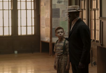 Young Malcolm Little, played by Mason Lowery, looks to his father Earl Little, played by Gbenga Akinnagbe, in GENIUS: MLK/X. (National Geographic/Richard DuCree)