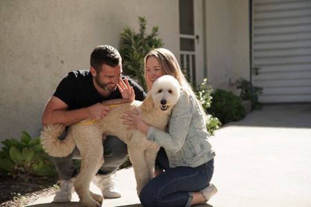 Thomas and Alex greet the new dog they've been matched with. (National Geographic)