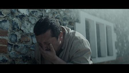 Local official leans against the wall in pain. He covers his mouth to block out the stench of sulfur. (Dash Pictures/Samuel Purcell, Oliver Watts)