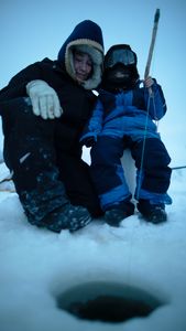 Tinmiaq Hailstone teaches her son Sabastian how to ice fish during the winter. (BBC Studios Reality Productions, LLC/Pedro Delbrey)