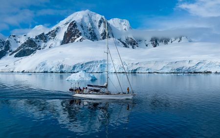 The Spirit of Sydney against a backdrop of a mountain range in the Antarctic Peninsula.  (credit: National Geographic/Bertie Gregory)