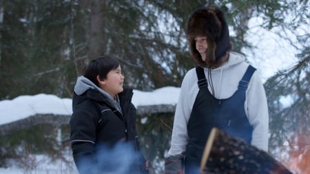 Keenan DeWilde and his father, Ricko DeWilde build a fire to honor a wolverine they successfully trapped. (BBC Studios/Ryan Walsh)