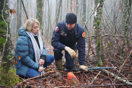 Alex Churchill and Guy Mom per from the Metz demining center inspect an unexploded munition in the "Red Zone" forest near Verdun, France. An area where an estimated 8 million shells fell without exploding during WW1. Many shells still remain untouched in the forest. (National Geographic/Ciaran Henry)