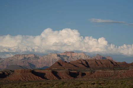 White clouds form behind Zion's Navajo sandstone mesas.  (National Geographic/Rick Smith)