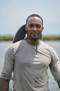 Anthony Mackie on the banks of the Violet Canal after planting restorative sea grass alongside volunteers from the Coalition to Restore Coastal Louisiana (CRCL). The canal is fed by the waters of the Mississippi River. (National Geographic/Brian Roedel)