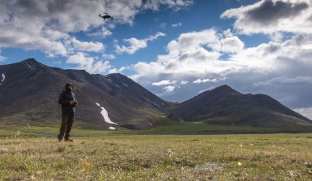 Camera operator Ryan Atkinson takes off with the drone. (National Geographic for Disney/Andrew Moorwood)