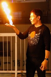 Cyril Takayama demonstrates his fire hand trick.  (National Geographic/Dana Hayes)