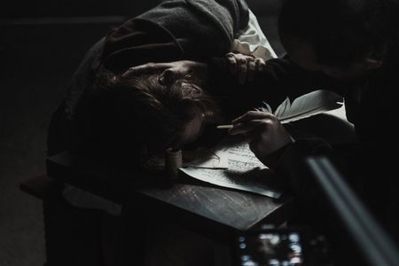 An accused woman is prodded with a quill, likely to test her endurance to pain. (Dash Productions Services LTD/Antoan Ivanov)