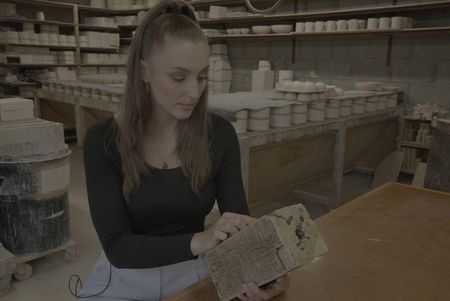 Lara Bampfield, expert in cuneiform archaeology holds a replica of the King's List found in southern Mesopotamia. (Windfall Films)