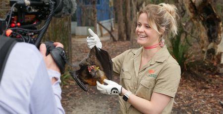 Sarah holding a bat upside down. (Big Wave Productions)