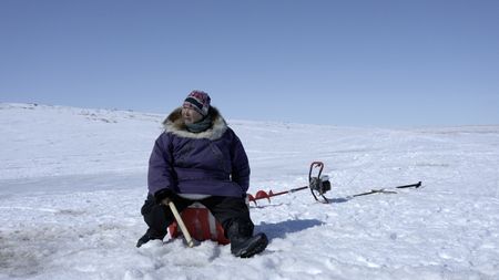 Teresa Pingayak ice fishing. (National Geographic/Matt Kynoch)