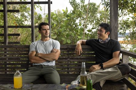 Antoni Porowski and Henry Golding sit down for a meal in Batang Ai. (Credit: National Geographic/Annice Lyn)