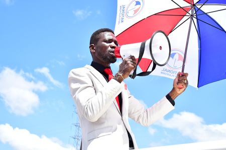 Ugandan politician Robert Kyagulanyi Ssentamu, also known as Bobi Wine, campaigns with a megaphone. Before they could reach the campaign venue in Kumi District, he and his campaign team were tear gassed and subjected to numerous obstacles by Ugandan security forces on November 15, 2020.(photo credit: Lookman Kampala)