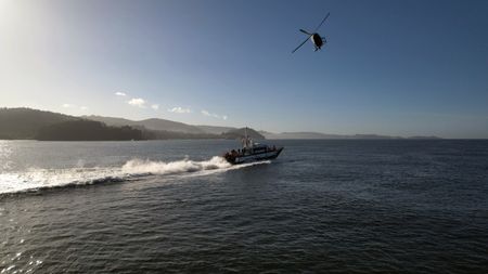 A helicopter and a patrol boat of Guardia Civil are pictured in Pontevedra, Spain. (National Geographic)