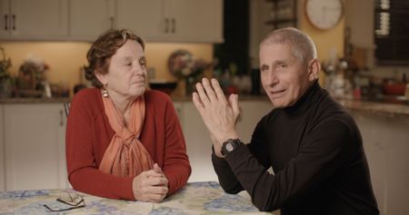 Dr. Anthony Fauci and Christine Grady sit at their kitchen table in December 2020.  (National Geographic for Disney+)