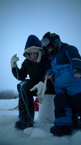 Tinmiaq Hailstone teaches her son Sabastian how to ice fish during the winter. (BBC Studios Reality Productions, LLC/Pedro Delbrey)