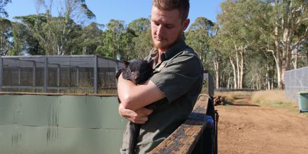 Tyler holding a tasmanian devil baby. (Big Wave Productions)