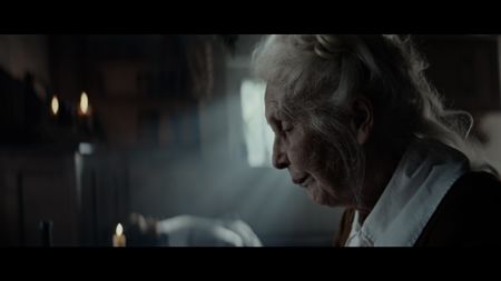 Ann Haltridge sits reading in her home. (Dash Pictures/Samuel Purcell, Oliver Watts)