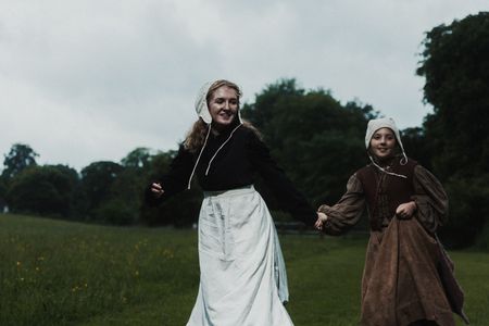 Gertrude runs through a field, hand in hand with Marit. (Dash Productions Services LTD/Antoan Ivanov)