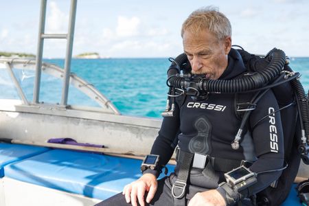 Series Director and DoP, Adam Geiger, preparing his CCR to dive and film Day octopus (Octopus cyanea) on the Great Barrier Reef.   (photo credit: National Geographic/Harriet Spark)