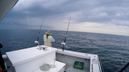 Gloucester, MA - Captain Brad Krasowski on the  Fish Hawk with lightning bolts on the horizon. (PFTV)