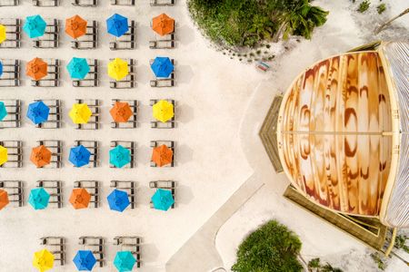 Beach umbrellas set up on the beach are seen in arial view on Lookout Cay at Lighthouse Point, The Bahamas. (Disney/Steven Diaz)