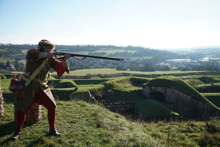 A reenactor firing a musket at Belfort Citadel, France. The iconic site played a vital role in the Franco-Prussian war. (National Geographic/Ciaran Henry)