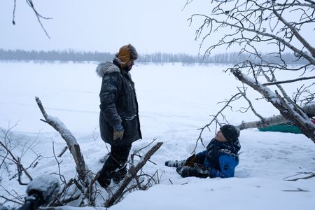 Chevie Roach teaches his son Ryder how to set marten traps along their trapline. (BBC Studios Reality Productions, LLC/Jayce Kolinski)