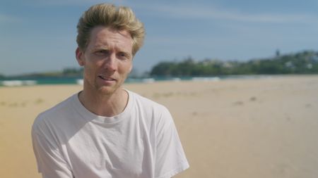 Brett Connellan, shark attack survivor being interviewed on Bombo Beach, Australia as he recalls his encounter with a shark and the events of that day. (National Geographic)