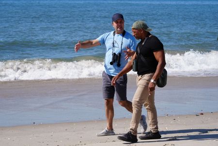 NYC Plover Project founder Chris Allieri explains the plight of New York's piping plover population as he and Christian Cooper walk down Fort Tilden beach. (National Geographic/Troy Christopher)