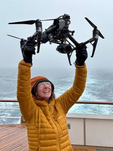 Producer Director Ruth Davies launches a drone from the expedition ship. (National Geographic for Disney/Raphael Boudreault-Simard)