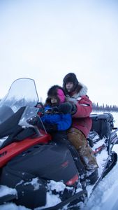 Ricko DeWilde with his son, Keenan DeWilde travel by snowmobile while setting fur traps. (BBC Studios Reality Productions, LLC/JR Masters)