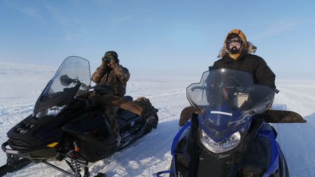 Nalu Apassingok and her brother Chris Apassingok scope out a nearby caribou herd. (National Geographic)