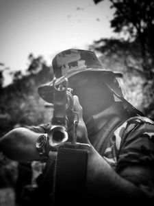 In Sinaloa Mountains, a narco soldier points a gun at the camera. (Nick Quested)