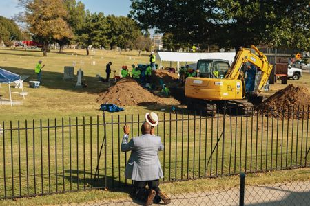 The Rev. Robert Turner of Vernon A.M.E. Church prays at Oaklawn Cemetery after learning that scientists found a mass grave during an excavation in the search for victims from the 1921 Tulsa Race Massacre. (Bethany Mollenkof/National Geographic)