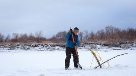 Ryder Roach helps his father check their fish nets in hopes of food. (BBC Studios/Brian Bitterfeld)