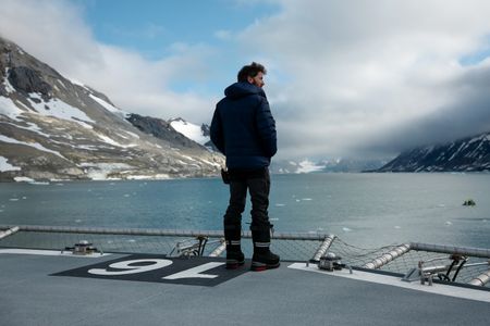 Aldo Kane standing at the bow of OceanXplorer. (National Geographic/Mario Tadinac)