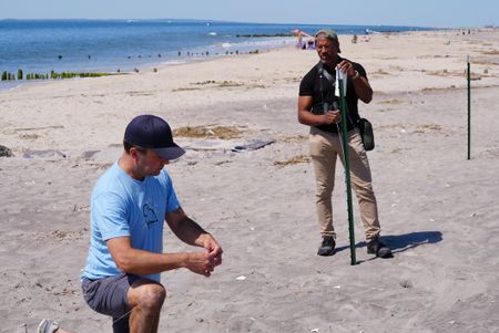 NYC Plover Project founder Chris Allieri and Christian Cooper set up symbolic fencing to protect piping plover nests at Fort Tilden. (National Geographic/Troy Christopher)