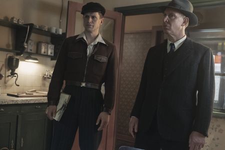 A SMALL LIGHT - Omnia Agents, played by Max Bennett and Paul Thornley, search the Gies household as seen in A SMALL LIGHT. (Credit: National Geographic for Disney/Dusan Martincek)