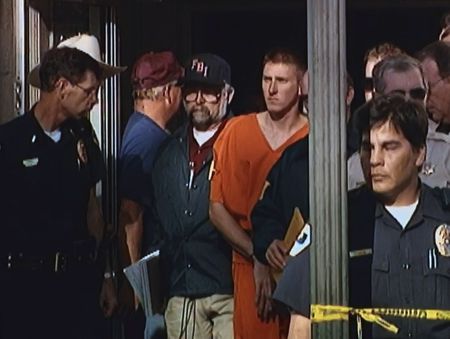 Timothy McVeigh is escorted out of the Noble County Courthouse in Perry, Oklahoma to be transferred to Tinker AFB for his arraignment, April 21, 1995. (News9 Oklahoma City)