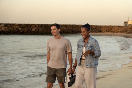 Antoni Porowski and Issa Rae walk on the beach in Dakar, Senegal. (National Geographic/John Wendle)